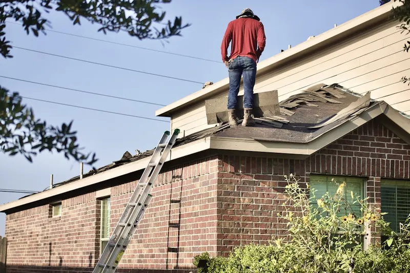 Professional roofer working on a residential roof in Bridgedale